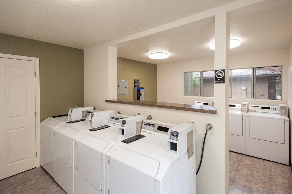 View of community laundry care facility with washer and dryers