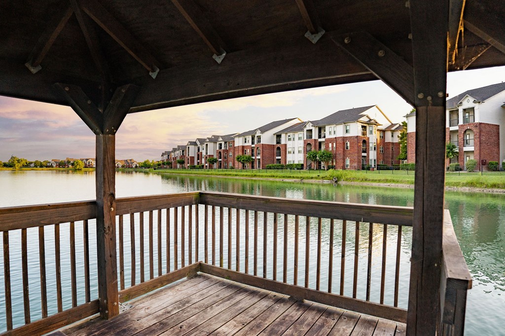 a view of a lake with an apartment complex in the background