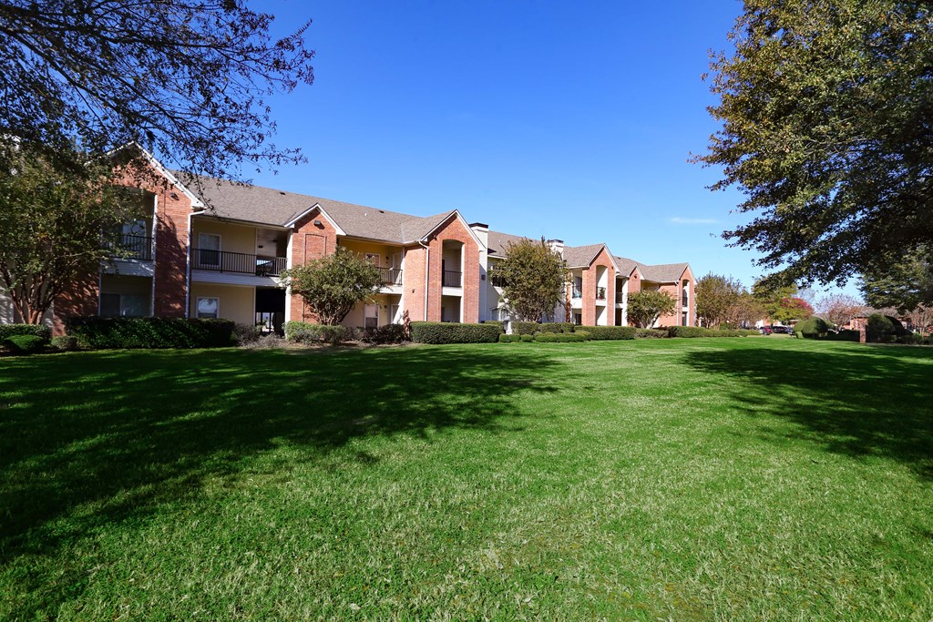 Exterior view of property with lush landscaping