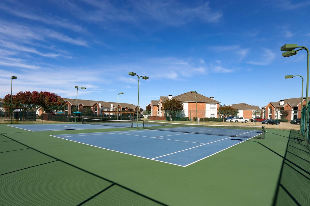 View of gated community tennis courts