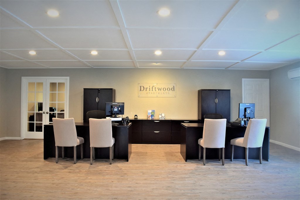 View of leasing office with brown desks and cabinetry and sitting area