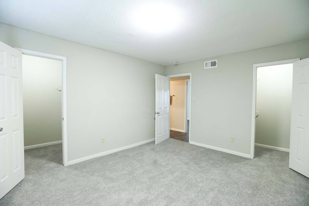 A large bedroom with walk in closets at Willow Creek Apartments, Texas
