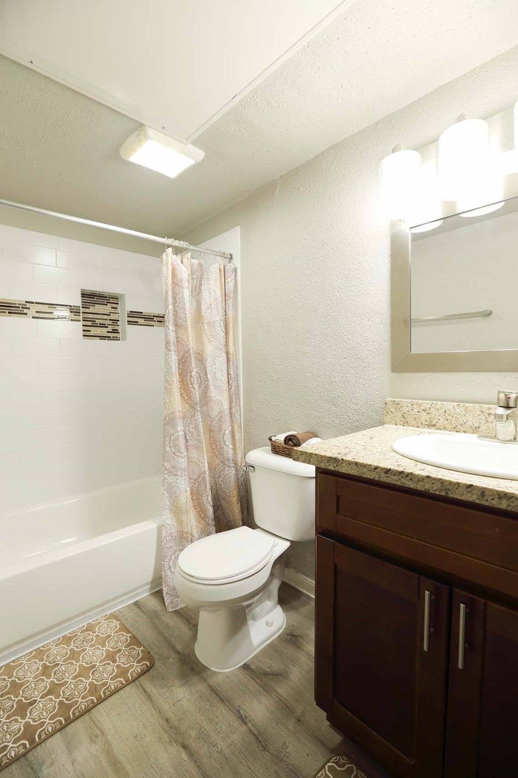 Bathroom with bathtub and large mirror at Willow Creek Apartments, Houston, TX, 77012