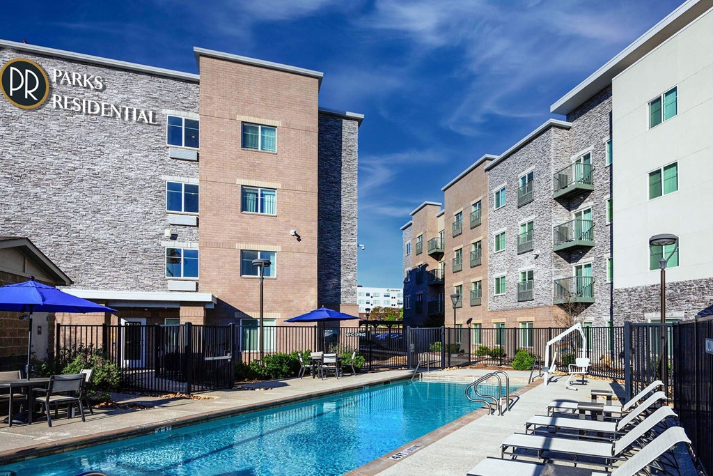 our apartments have a large pool and lounge chairs our apartments have a large pool and lounge chairs at Parks Residential - Richardson, Richardson, 75082