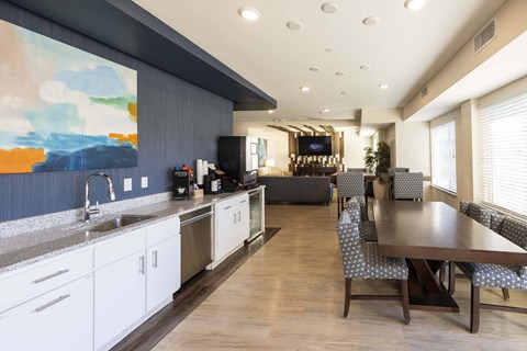 a kitchen and dining room with a table and chairs