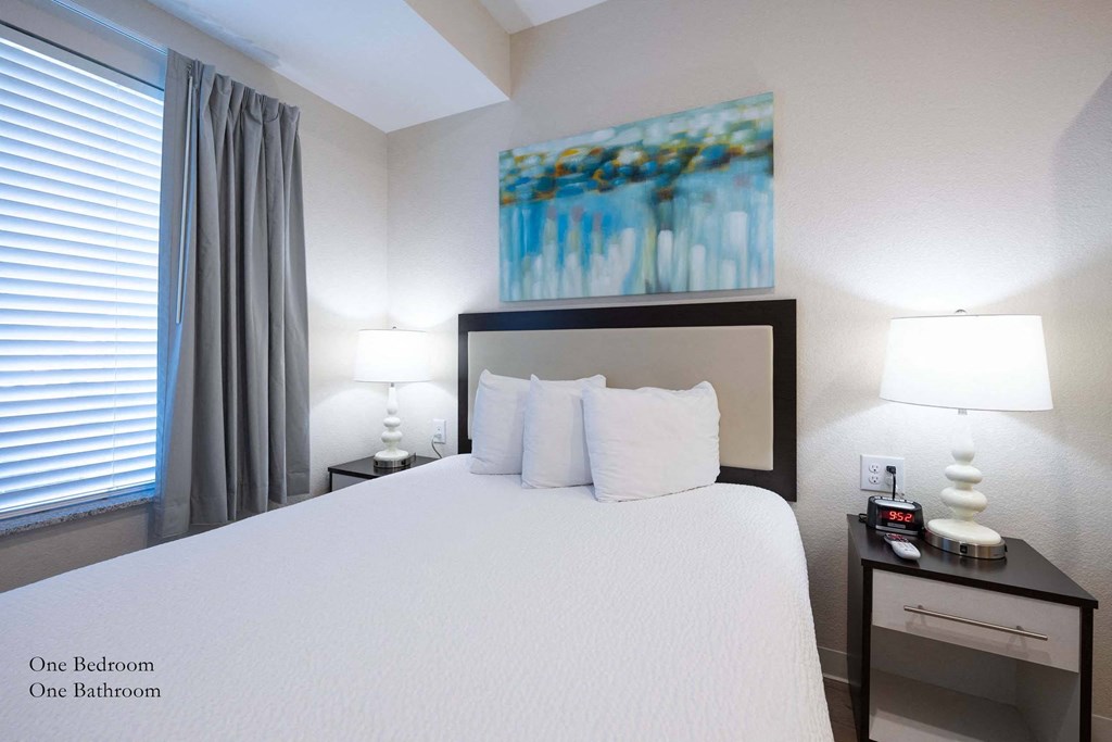 a bedroom with a large bed and a window at Parks Residential - Richardson, Texas