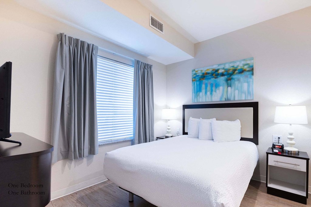 a bedroom with a large white bed and a window a bedroom with a large white bed and a window at Parks Residential - Richardson, Texas, 75082