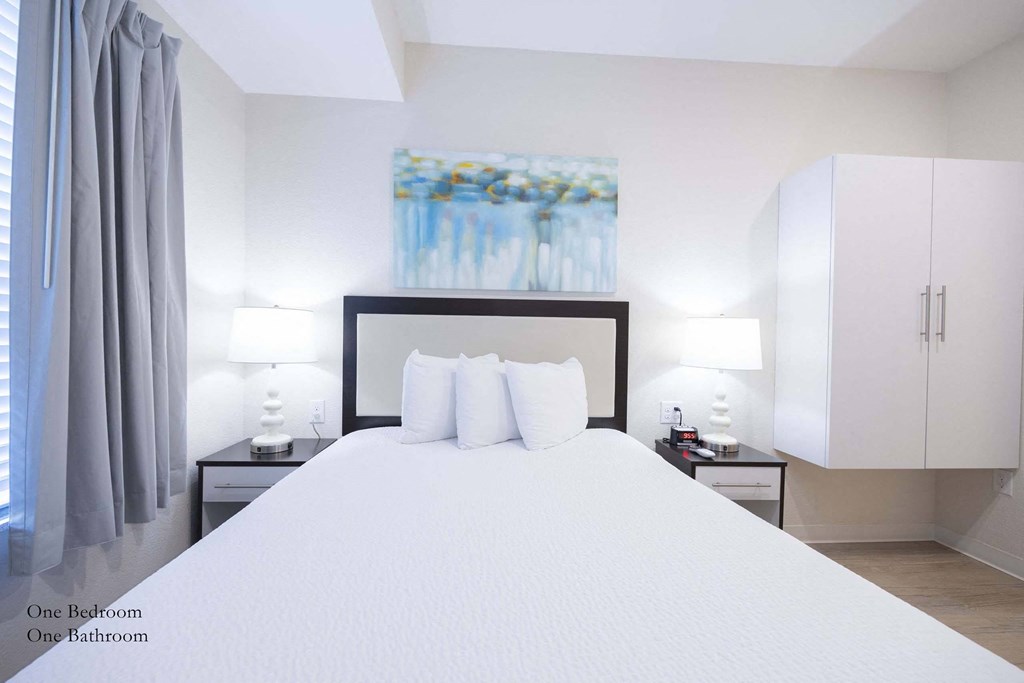 a bedroom with a large white bed and white cabinets at Parks Residential - Richardson, Richardson, Texas