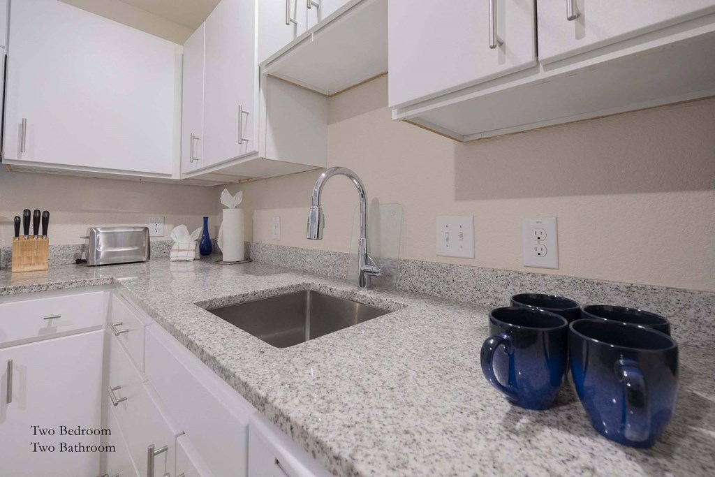 a kitchen with granite counter tops and a sink at Parks Residential - Richardson, Richardson, 75082