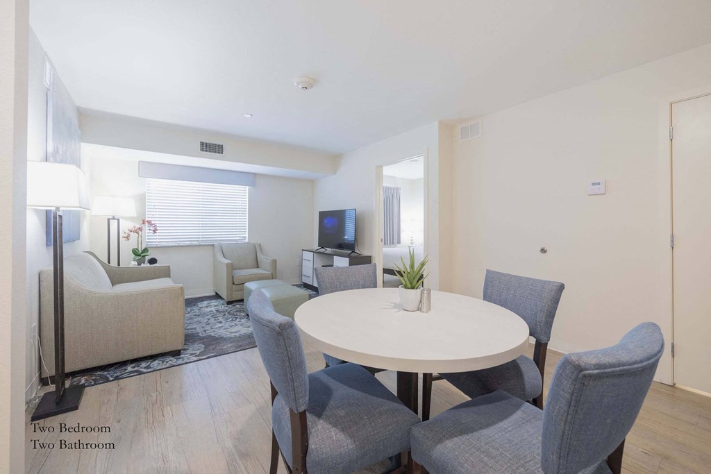 a living room with a white table and chairs at Parks Residential - Richardson, Texas