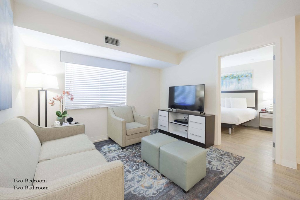 a living room with a couch and a tv at Parks Residential - Richardson, Richardson