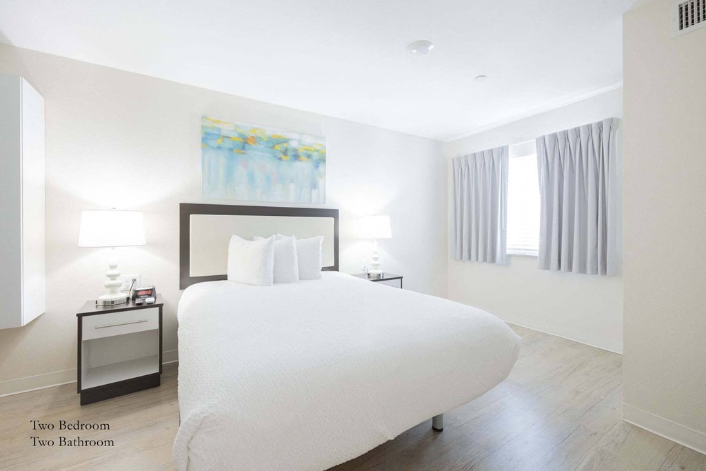 a bedroom with a large white bed and two nightstands at Parks Residential - Richardson, Texas, 75082