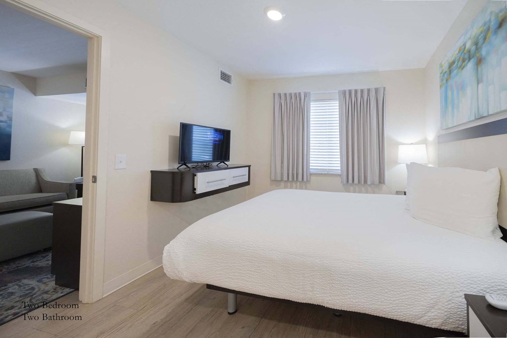 a bedroom with a bed and a tv in a hotel room at Parks Residential - Richardson, Richardson, 75082