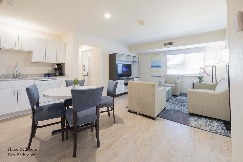 a dining room and kitchen area with a table and chairs at Parks Residential - Richardson, Texas