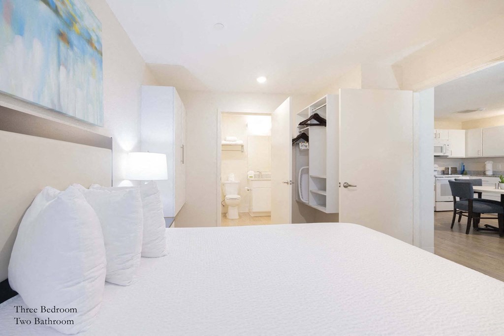 a bedroom with a bed and a closet and a bathroom at Parks Residential - Richardson, Texas, 75082