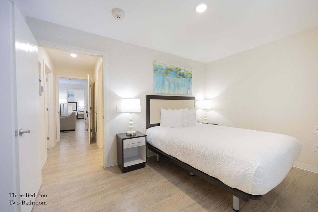 a bedroom with a large white bed and a white at Parks Residential - Richardson, Richardson, 75082