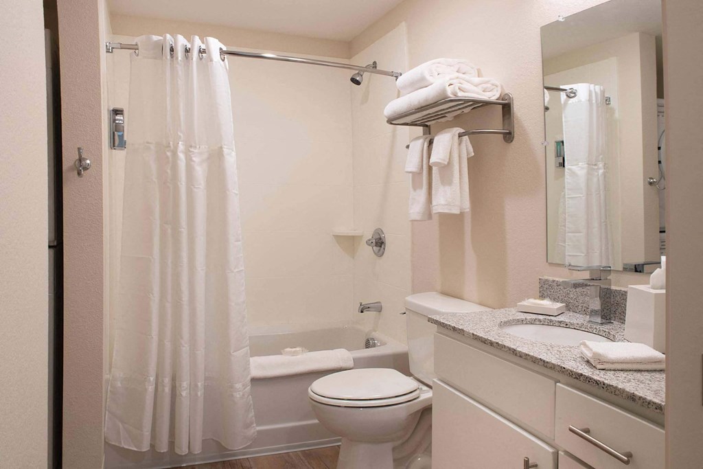 a bathroom with a shower and a sink and a toilet at Parks Residential - Denver, Colorado