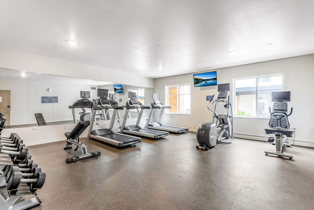 the gym with treadmills and other exercise equipment at the belgard apartments at Parks Residential - Denver, Centennial, 80111
