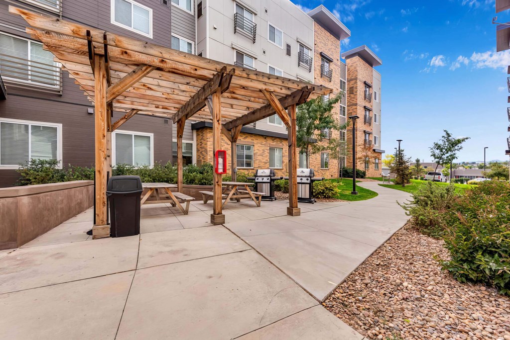 our apartments have a spacious patio with a wood pavilion and picnic tables at Parks Residential - Denver, Colorado