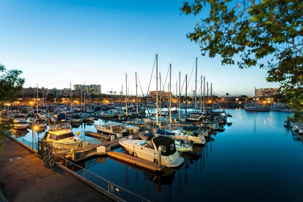 A marina filled with lots of boats docked in the water.