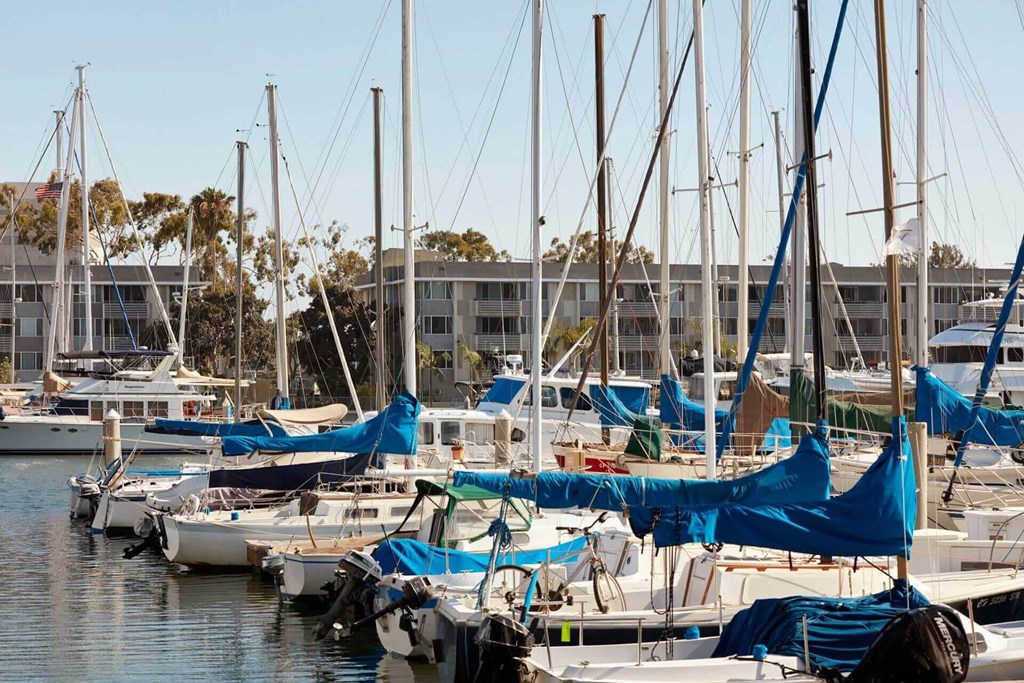 A marina with boats and a building in the background.
