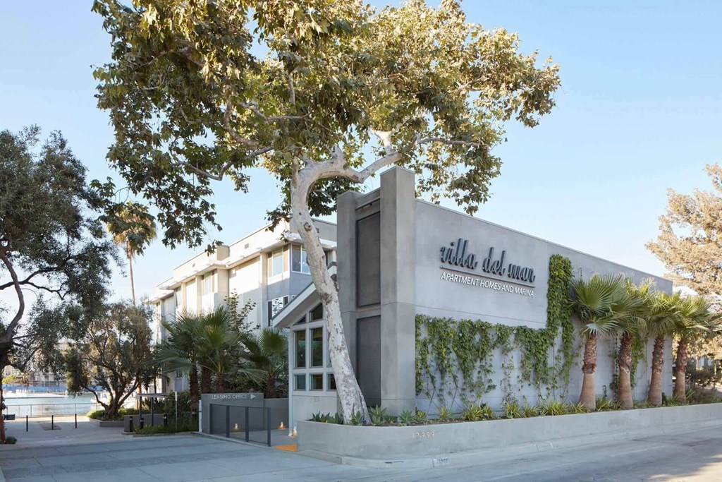 A villa sign is on the side of a building.