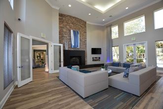 a large living room with couches and a fireplace