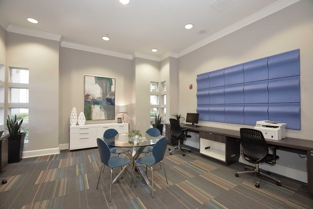 a conference room with a desk and chairs and a table