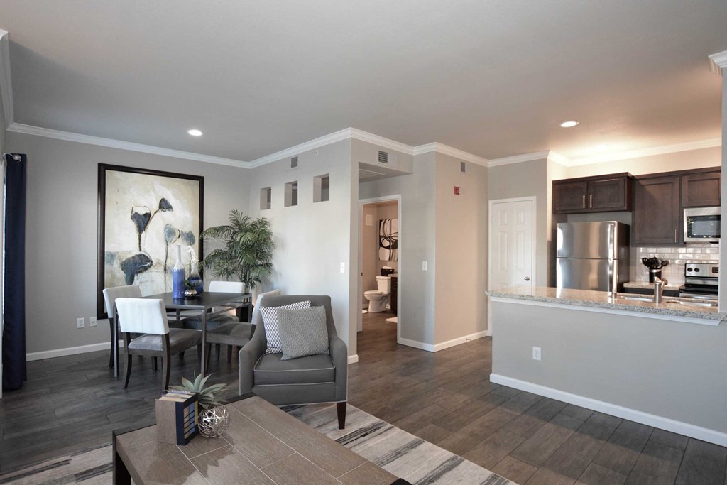 a living room and kitchen with a table and chairs