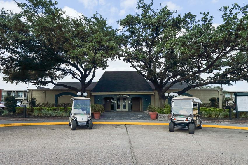 two golf carts parked in front of a building