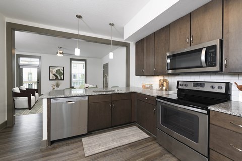 A modern kitchen with a stainless steel dishwasher and oven.