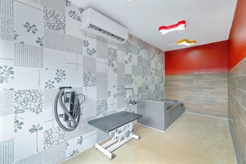 A bathroom with a shower and a bench.