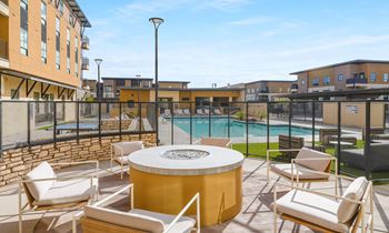 Poolside area with a hot tub and chairs at Solace at Ballpark Village, Goodyear