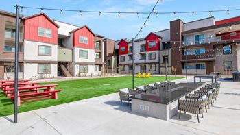 A red and white building with a patio and chairs.