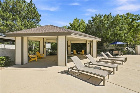 A house with a pool and sun loungers.