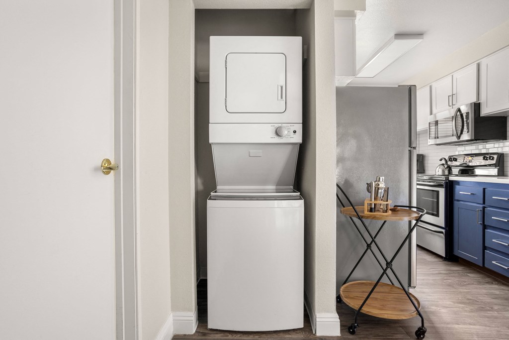 a small washer and dryer in a kitchen