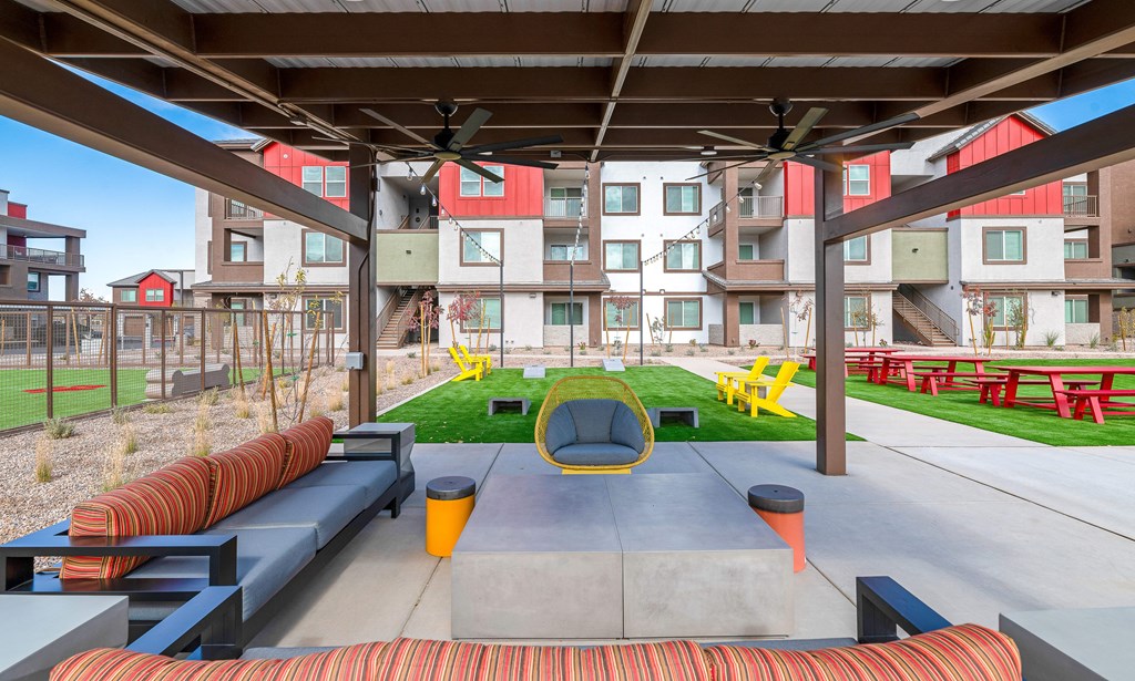 A modern outdoor seating area with a concrete table and chairs. at Weylyn Luxury Apartments, Laveen, Arizona