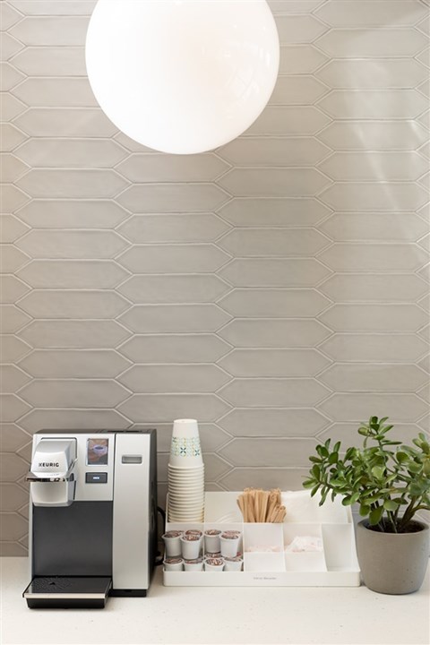 A grey wall with a vending machine and a potted plant.at The 89 on Hayden, Scottsdale, AZ 85257  
