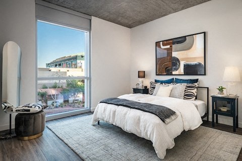a bedroom with a bed and a large window