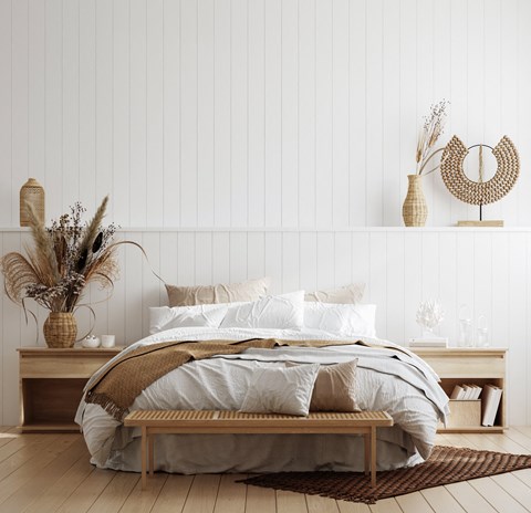 Coastal bedroom with natural wood furniture at Legado Apartments, Arizona