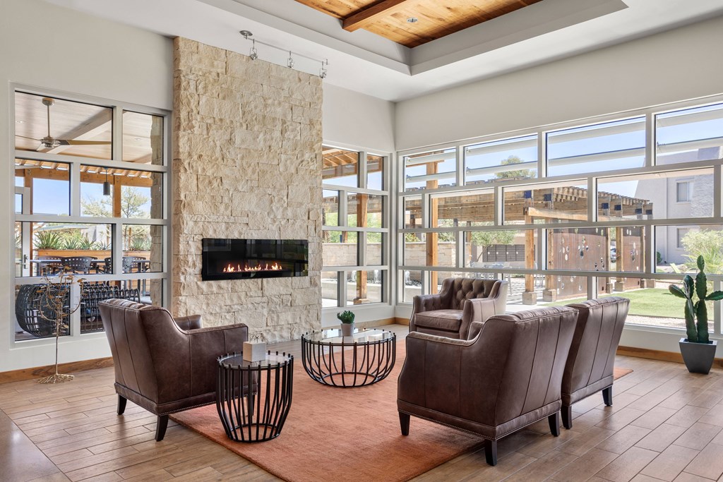 a living room filled with furniture and a large stone fireplace