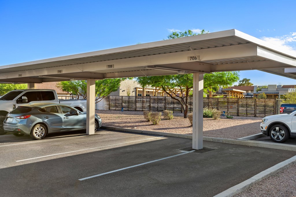 a carport in a parking lot with cars in the parking lot