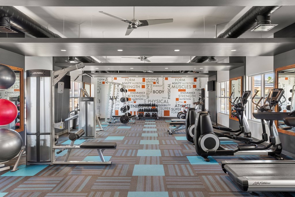 a spacious fitness center with treadmills and other exercise equipment