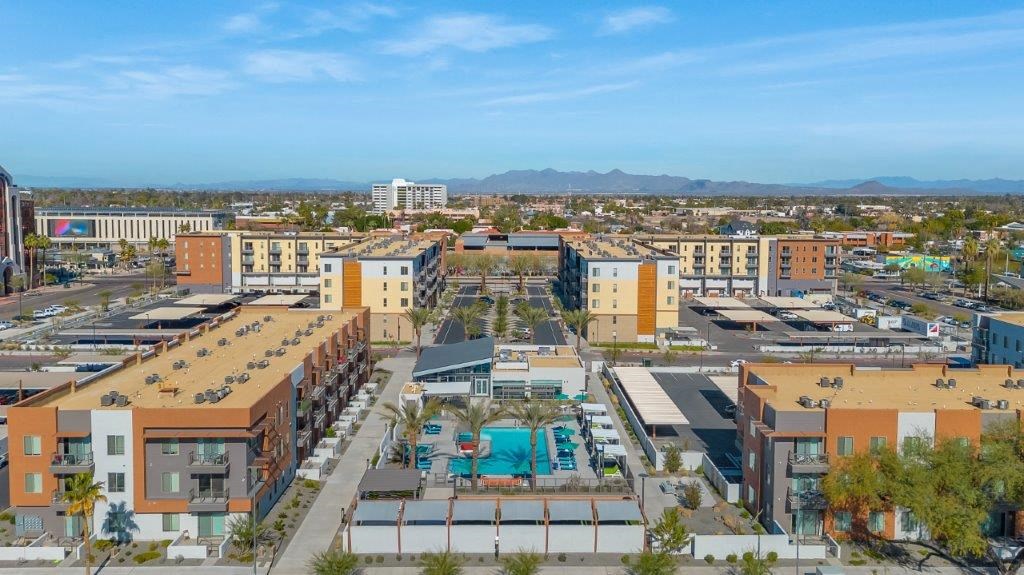 an aerial view of a city with buildings and a pool
