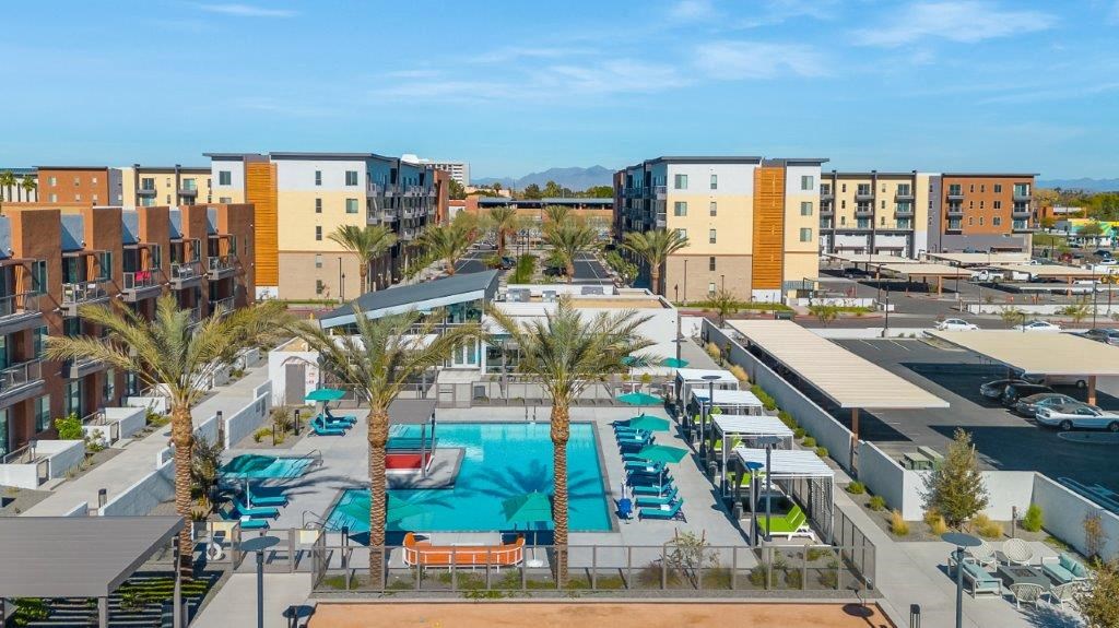 an aerial view of a swimming pool with palm trees