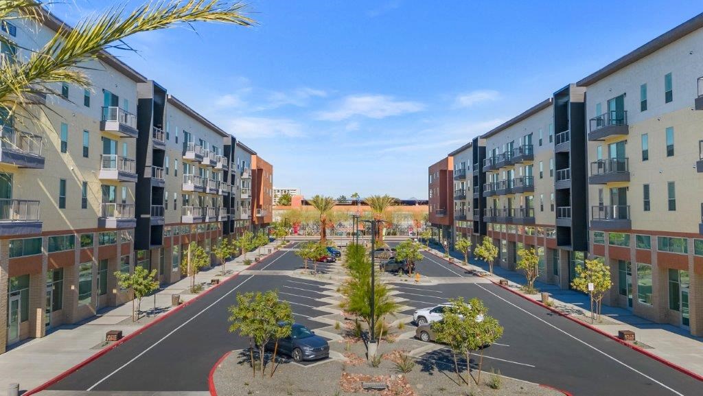 an aerial view of an empty street with rows of apartment buildings