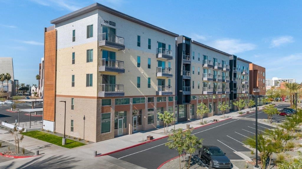an apartment building with a parking lot and a street