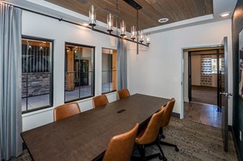 A conference room with a long table and chairs.