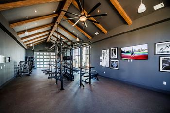 A room with a ceiling fan and pictures on the wall.