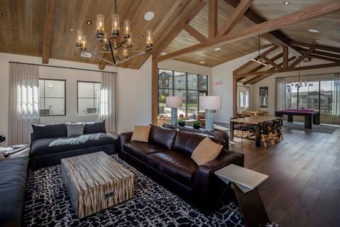 A modern living room with a dark brown leather couch and a wooden coffee table.